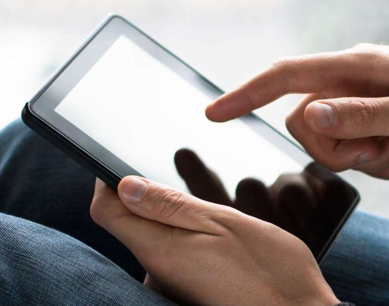 close up of hands using a tablet