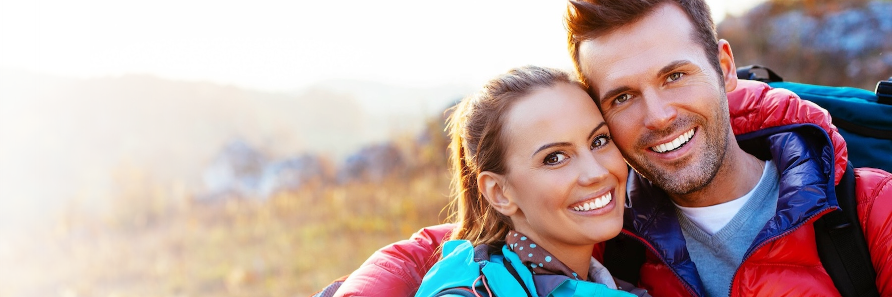 man and woman hugging while out on a hike in troy