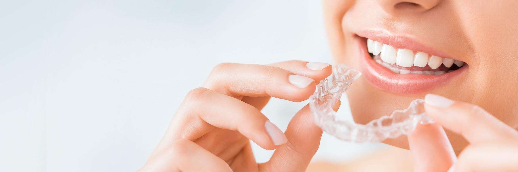 close up of woman holding invisalign