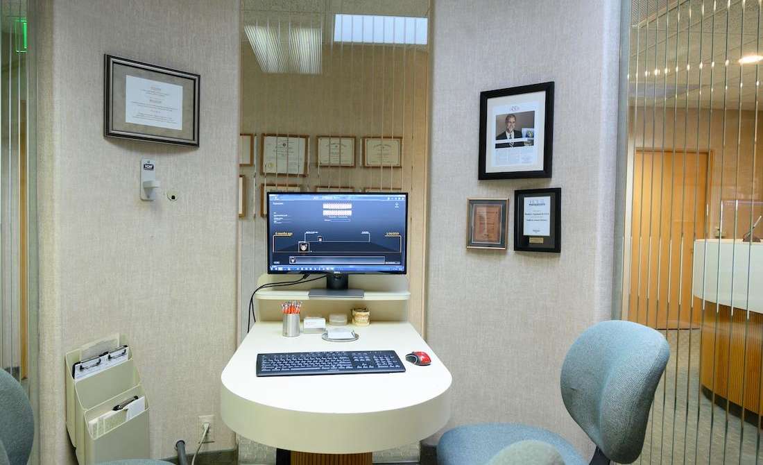 Consultation room with computer and desk chairs in troy