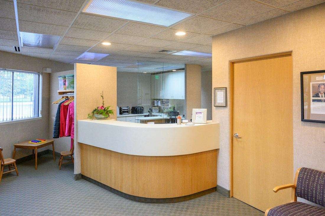 Modern office reception desk with a stylish curved white counter in Troy