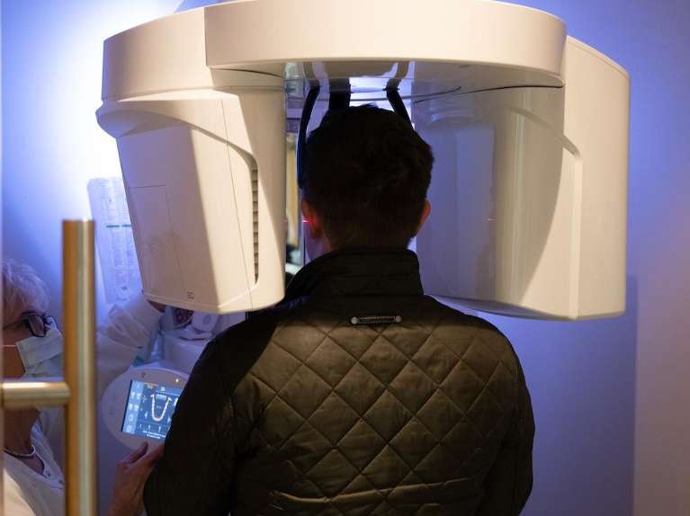 patient standing in panoramic x-ray machine